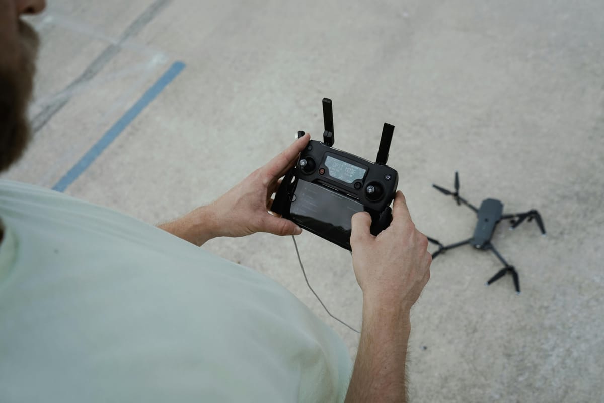 Drone operator performing pre-flight inspection at remote site