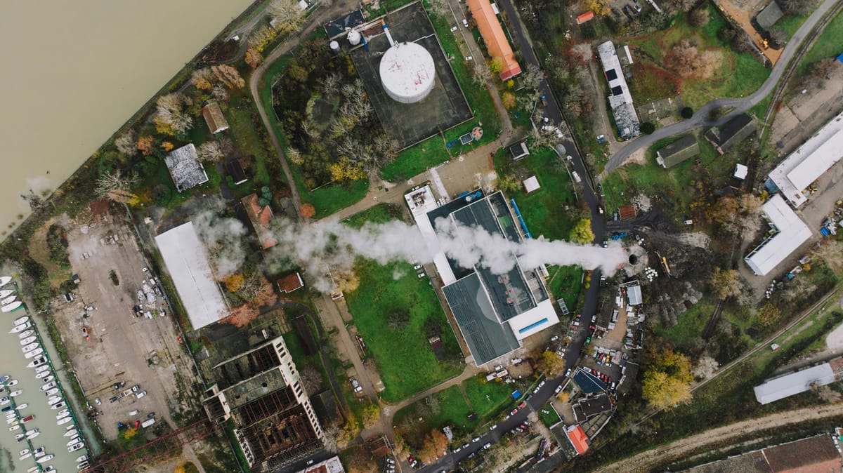 Aerial view of an industrial factory complex with multiple large buildings.