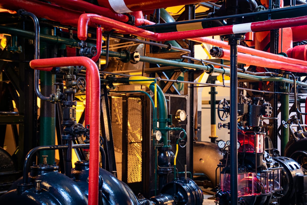 Aerial view of complex industrial pipes and machinery infrastructure.