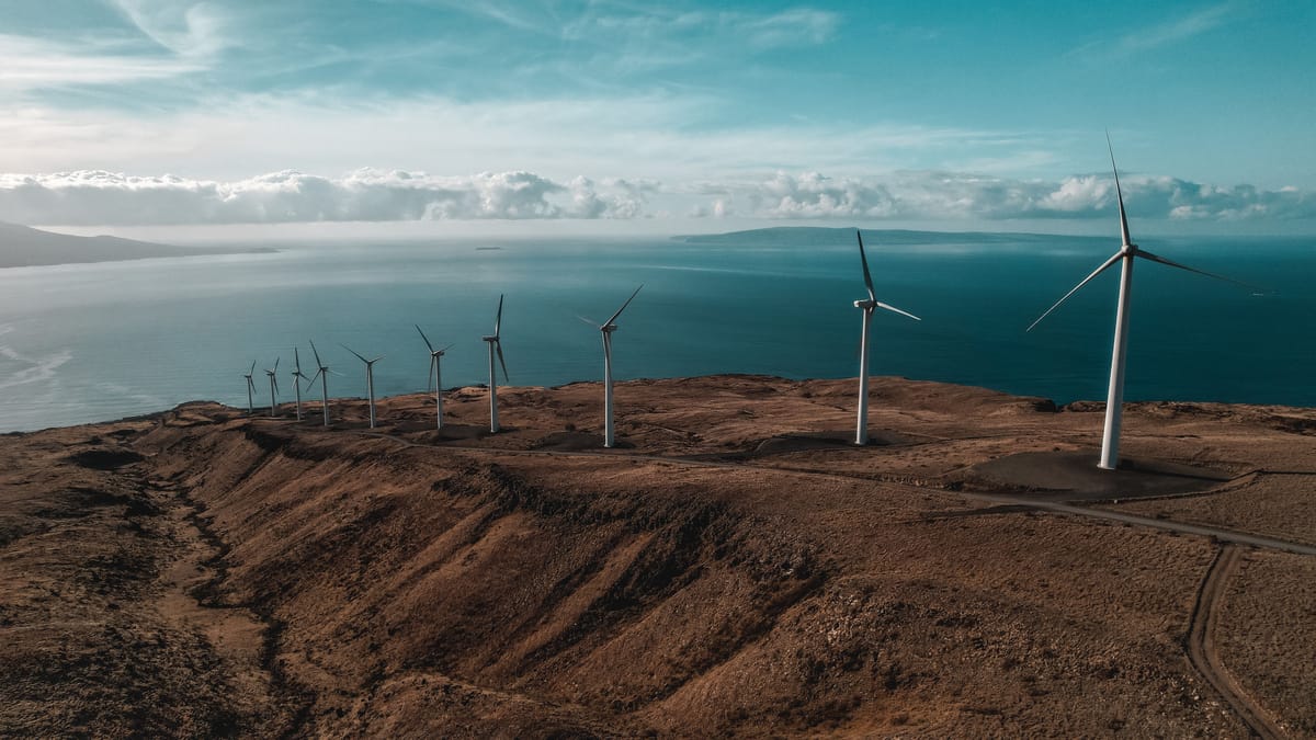 Aerial view of wind turbines near water.