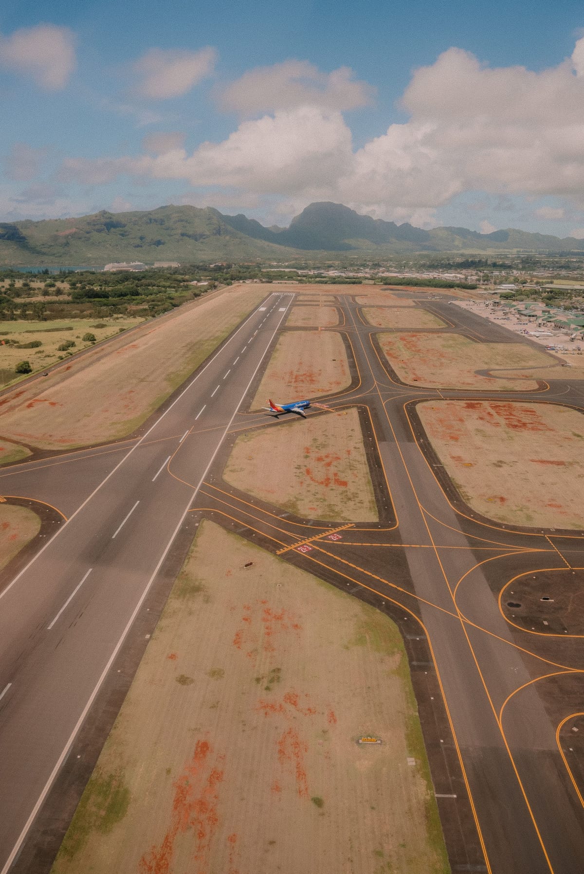 Aerial view of an airplane on an airport runway.