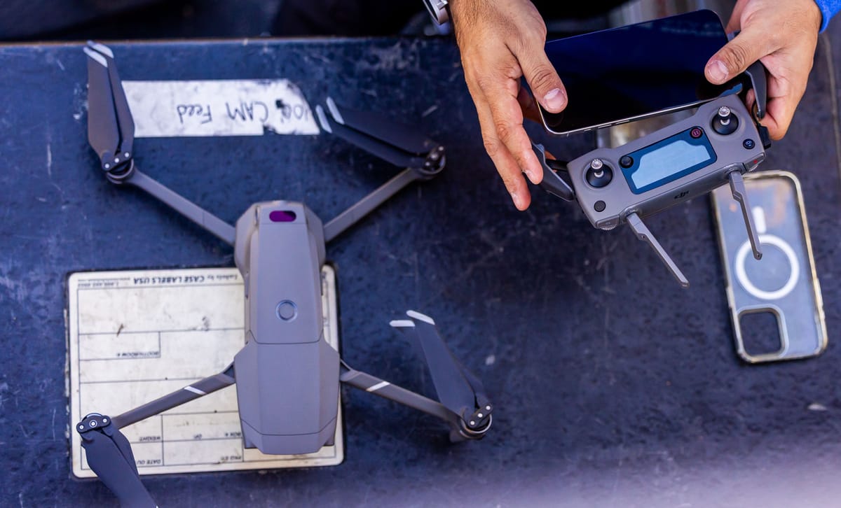 Drone and controller arranged on an outdoor table before a flight.