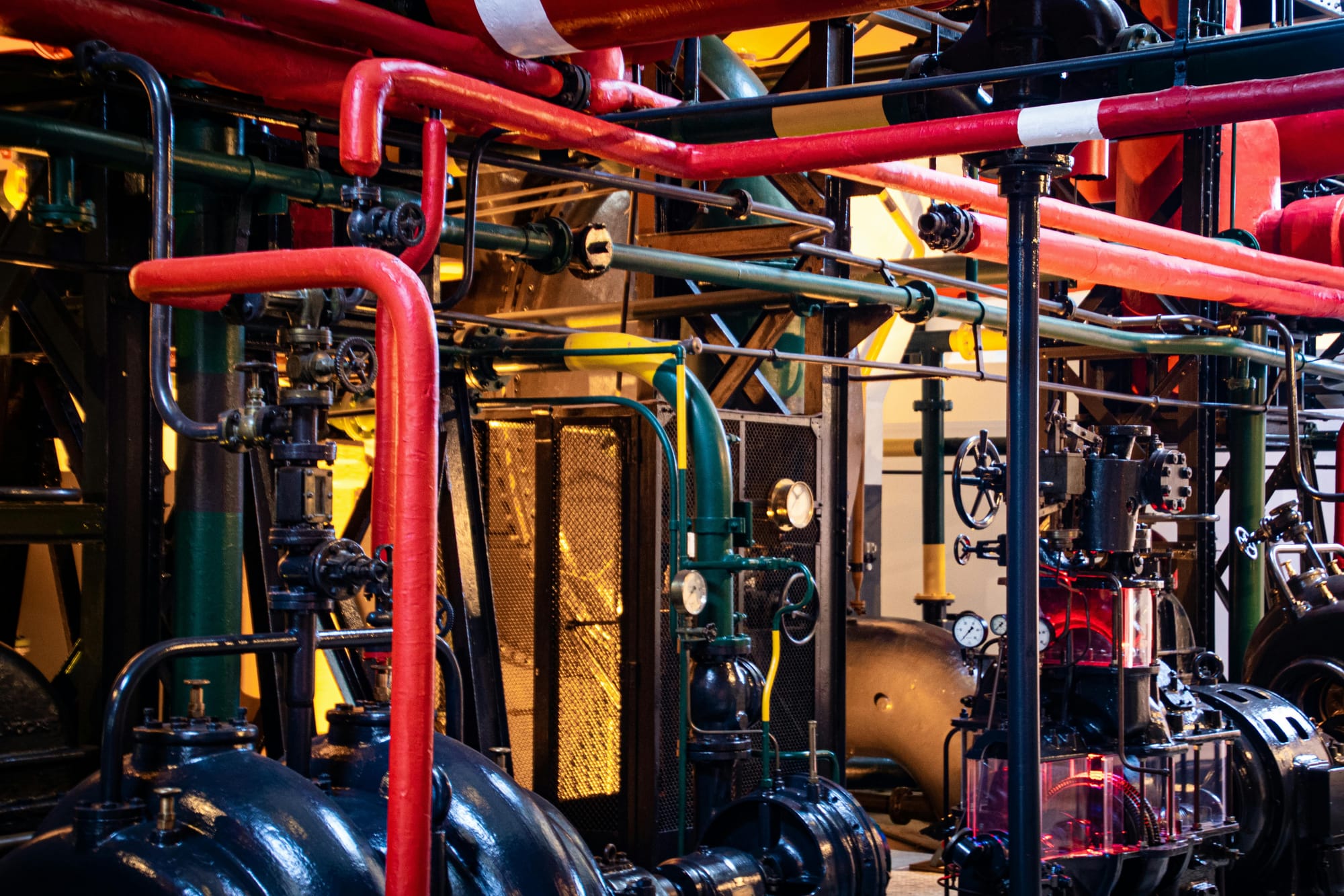Aerial view of complex industrial pipes and machinery infrastructure.