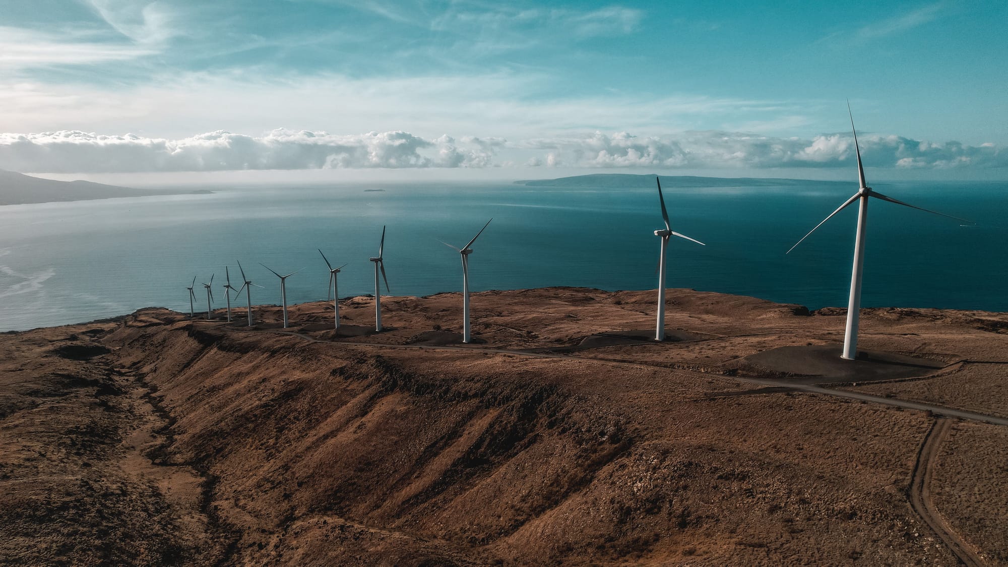Aerial view of wind turbines near water.