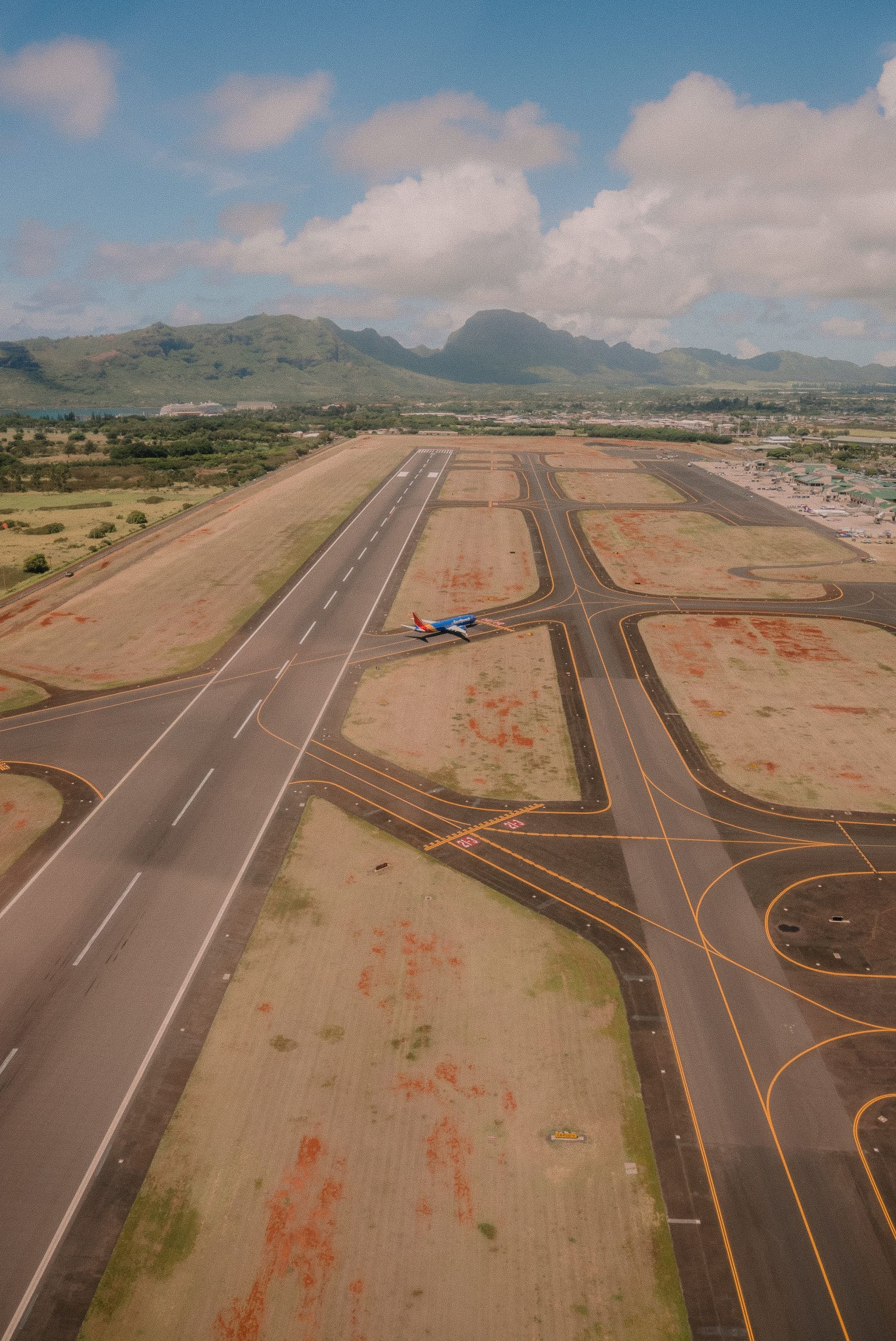 Aerial view of an airplane on an airport runway.