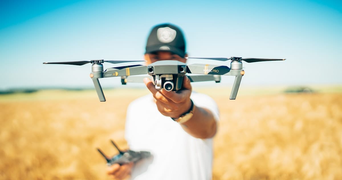 Drone pilot reviewing flight notes beside a controller before a mission.