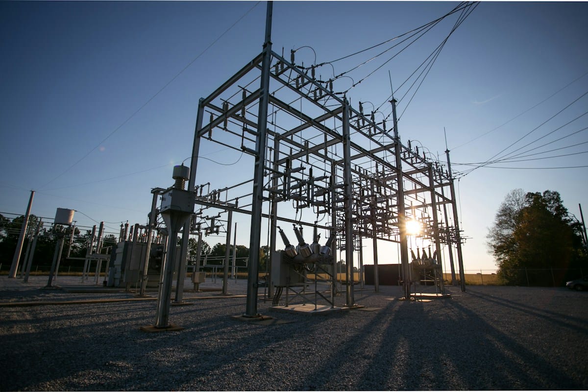 Steel structures and electrical conductors at a substation in low sunlight.
