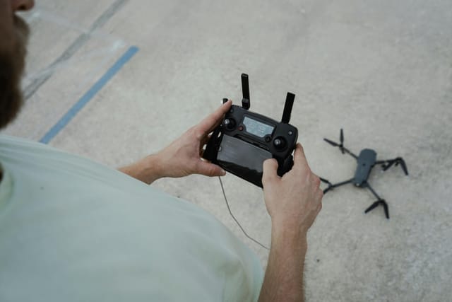 Drone operator performing pre-flight inspection at remote site