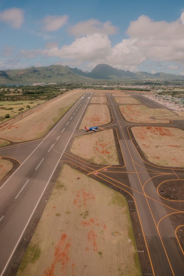 Aerial view of an airplane on an airport runway.